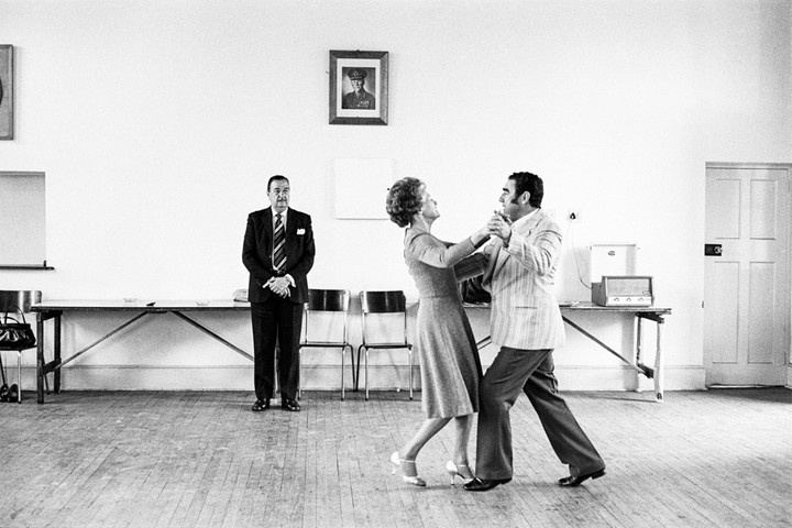 David Goldblatt — Dancing-master, Ted van Rensburg, watches two of his ballroom pupils swinging to a recording of Victor Sylvester and his Orchestra, in the MOTHS’ Hall at the old Court House