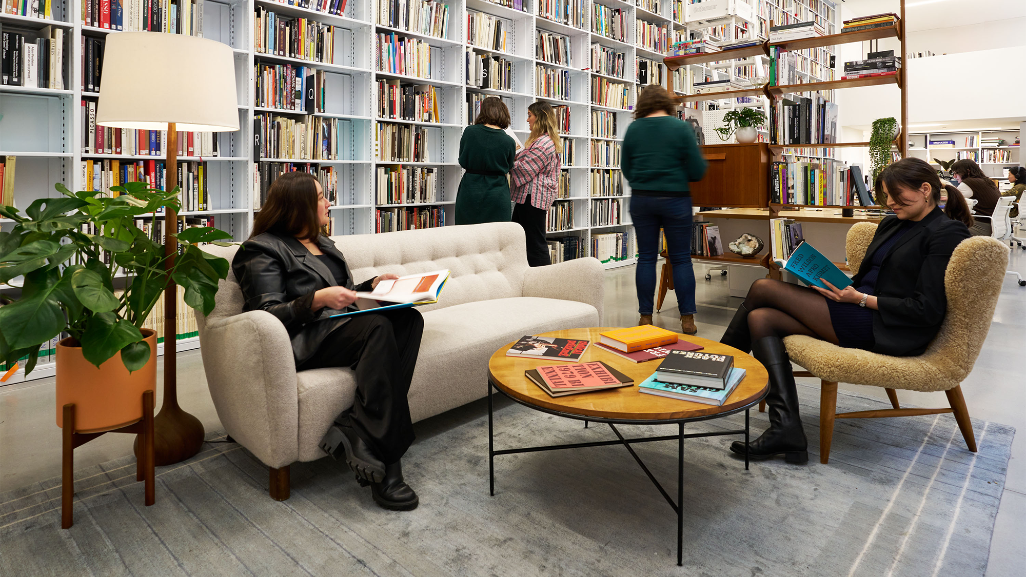 People Browsing Books in a Library